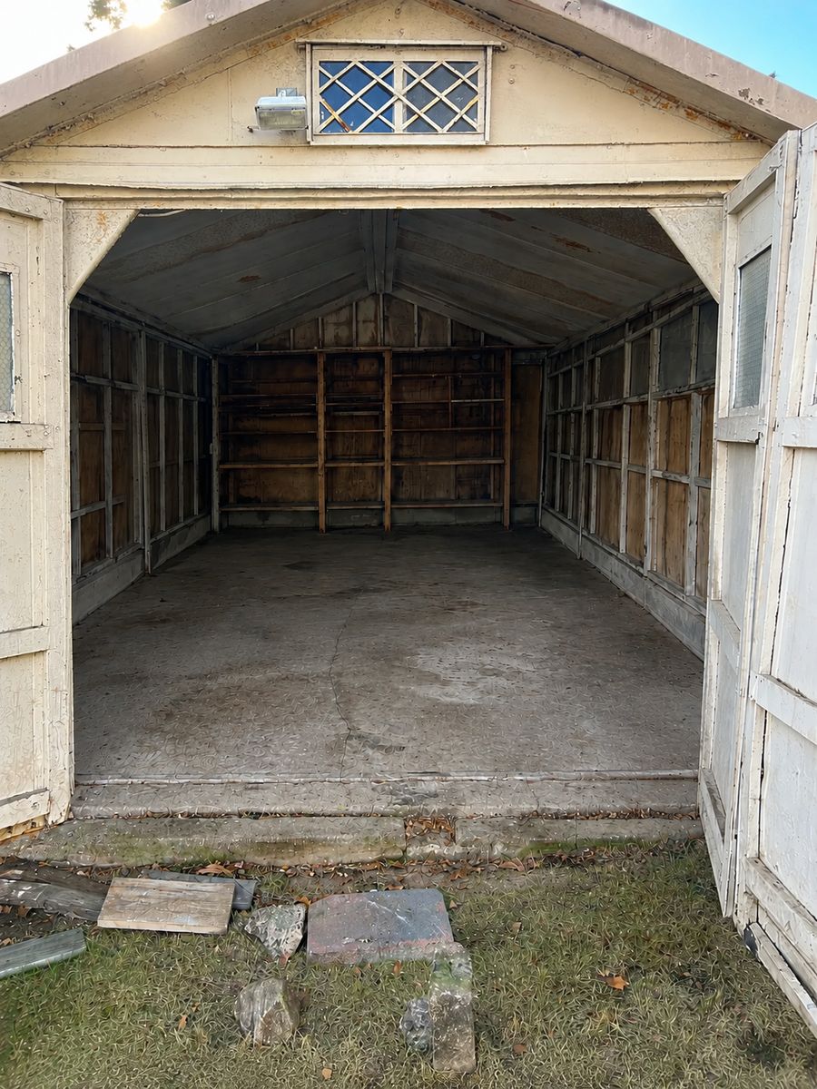 Empty, swept-out backyard shed after cleanout by Deadlift Junk Removal in Queens